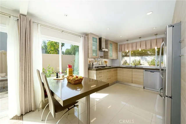 a kitchen with stainless steel appliances a refrigerator sink and microwave