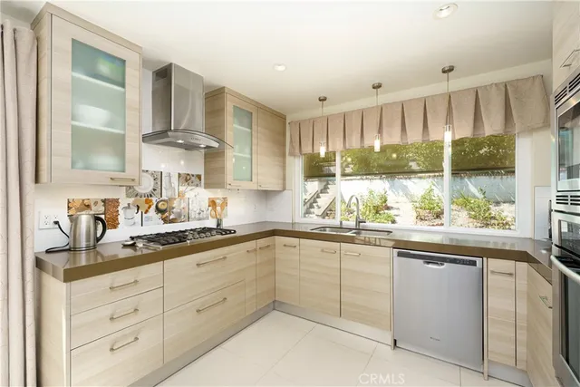 a dining hall with stainless steel appliances a dining table and chairs