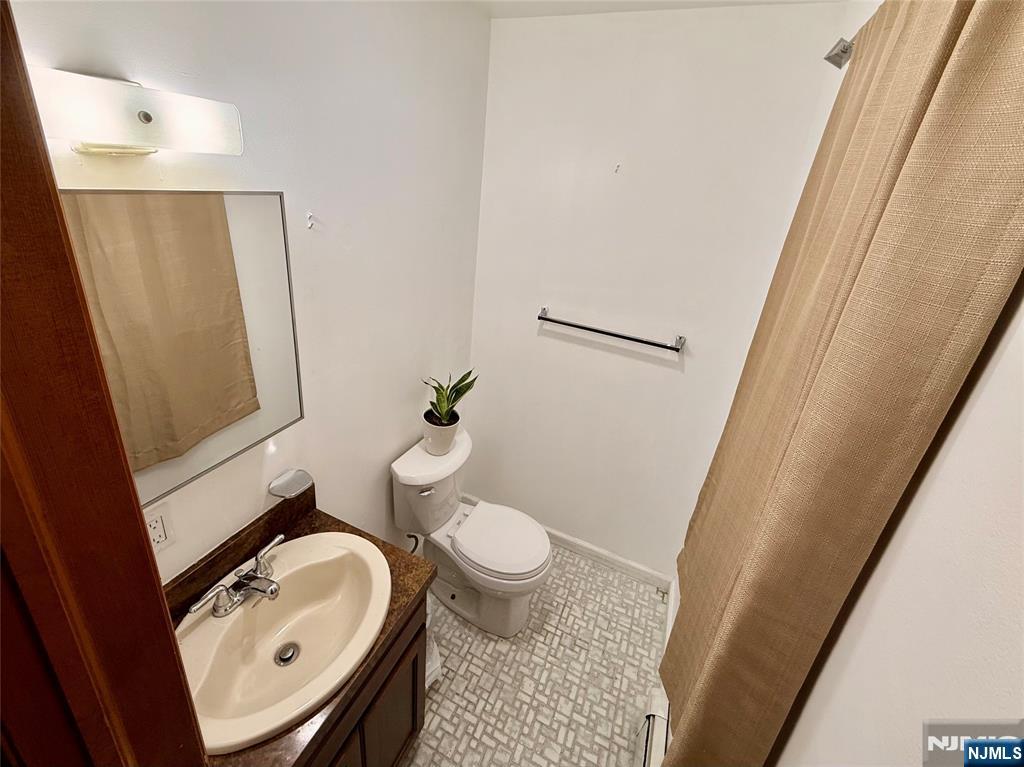 154 Cork Hill Road Franklin, NJ 07416 - Photo 12 of 35 a bathroom with a sink a toilet and a mirror