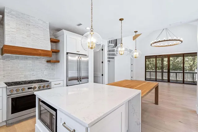 a kitchen with a stove a sink and a refrigerator