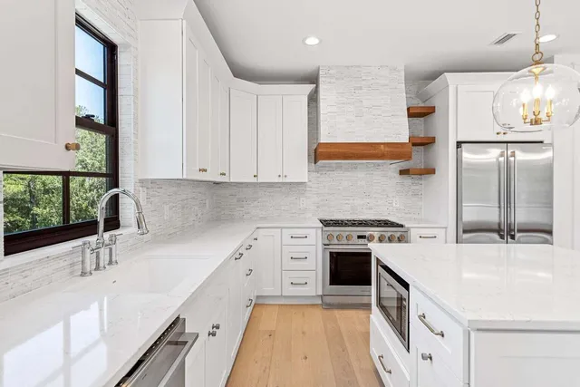 a kitchen with a sink stove and refrigerator