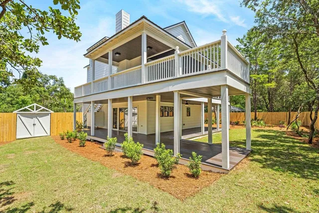 a view of a house with backyard and porch