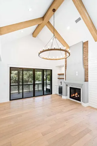 a view of an empty room with window and fireplace