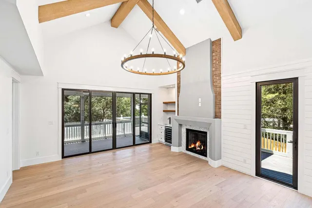 a view of an empty room with a fireplace and a window