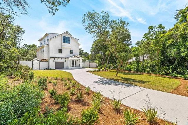 a view of house with swimming pool and a yard