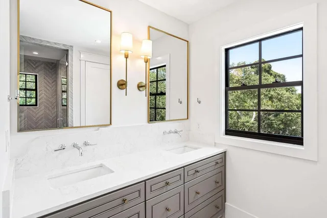 a bathroom with a sink and a large mirror