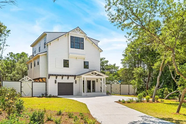 a view of a white house with swimming pool in front of it