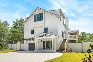 a view of a white house with a swimming pool