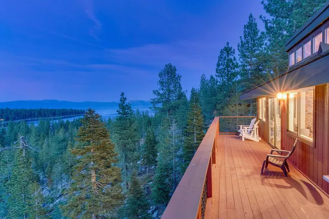 a balcony with wooden floor and outdoor seating