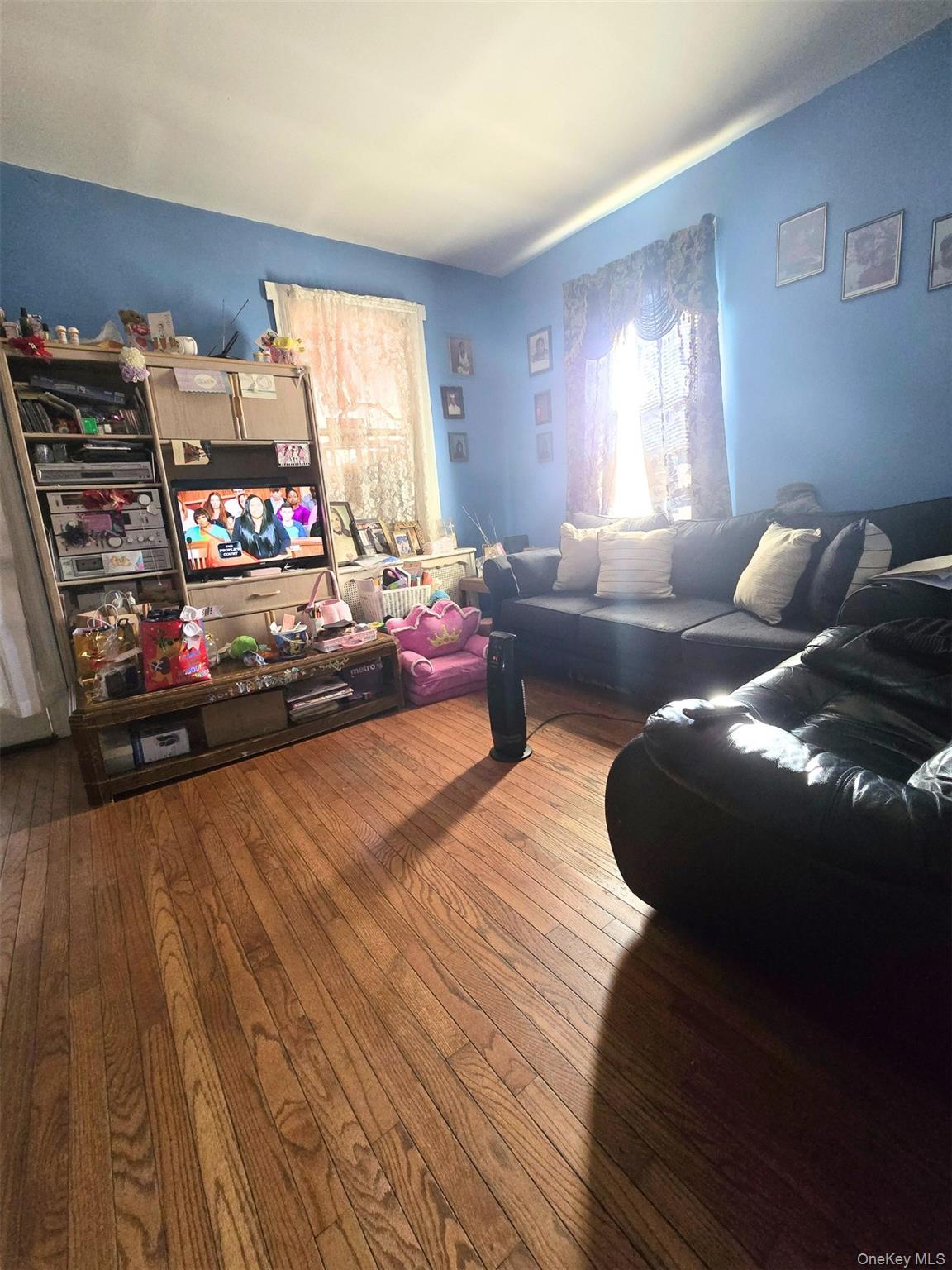 27 Midwood Street Hempstead, NY 11550 - Photo 11 of 13 a living room with furniture and a window