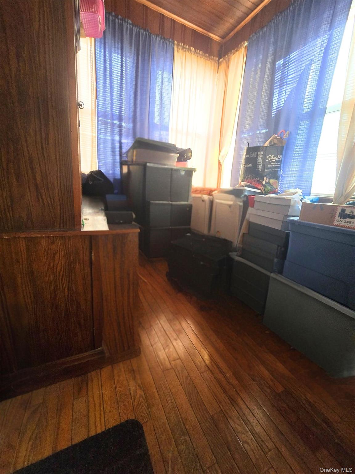 27 Midwood Street Hempstead, NY 11550 - Photo 13 of 13 a kitchen with wooden floors and a window