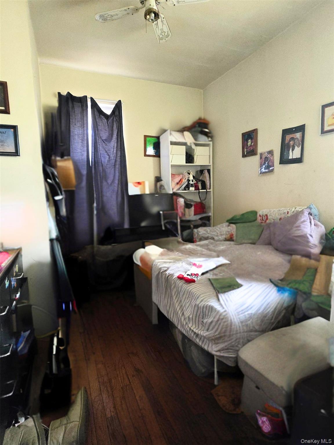 27 Midwood Street Hempstead, NY 11550 - Photo 6 of 13 a bedroom with bed and a mirror