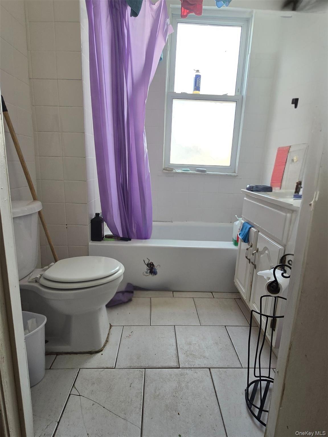 27 Midwood Street Hempstead, NY 11550 - Photo 7 of 13 a bathroom with a toilet and a shower