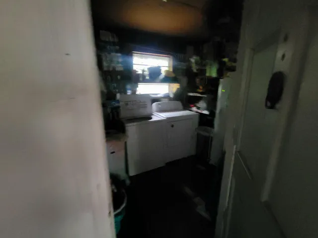 a room with water heater and wooden cabinets