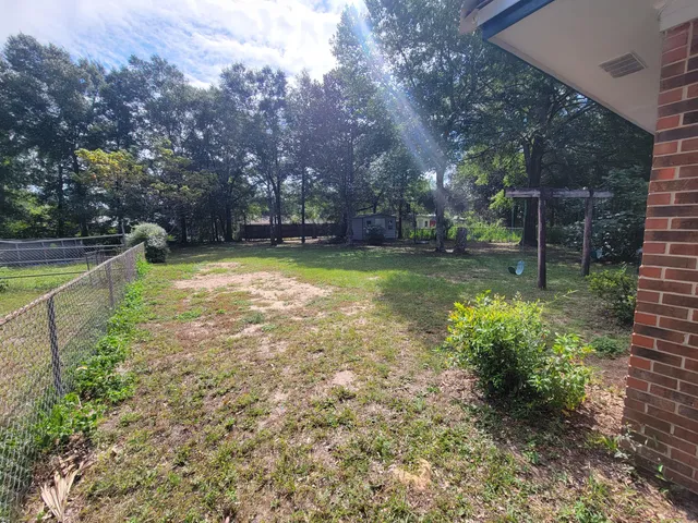 a view of a backyard with swimming pool