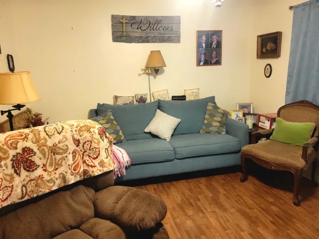 a living room with couches and painting on the wall
