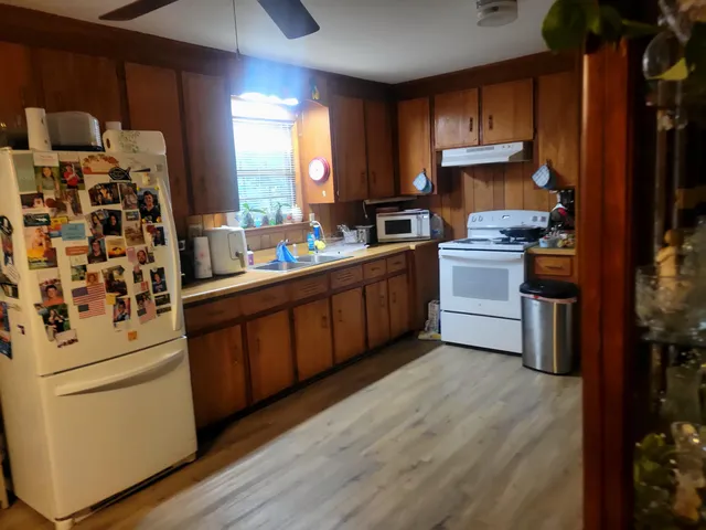 a kitchen with stainless steel appliances a stove a sink and a refrigerator