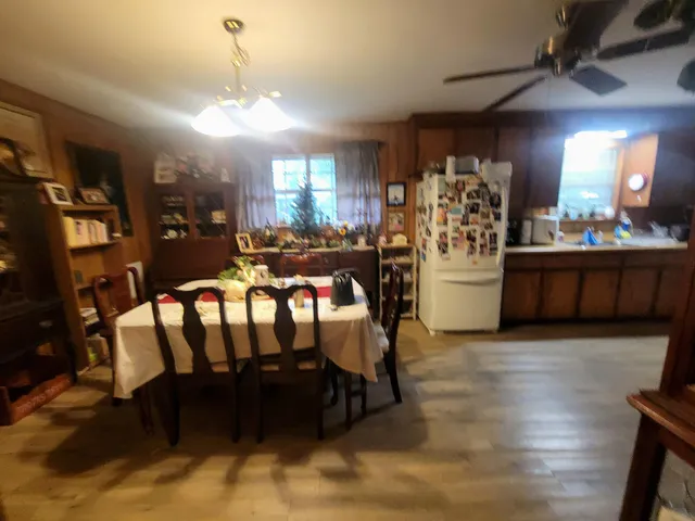a view of a dining room with furniture and chandelier