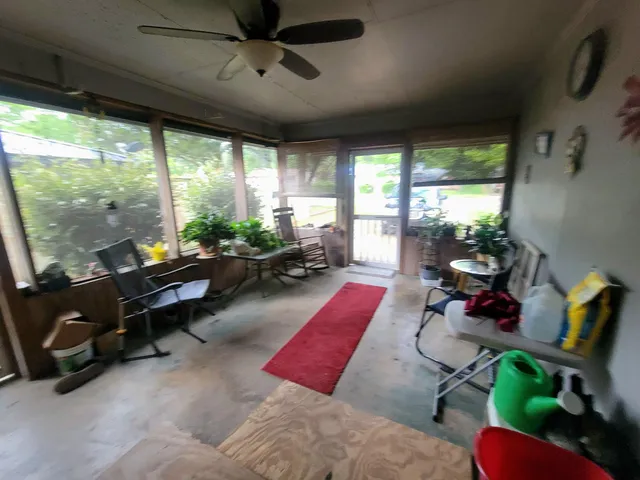a living room with furniture and a floor to ceiling window