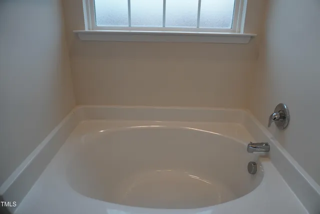 a bath tub sitting next to a window