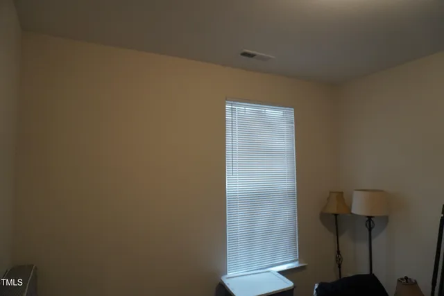 a bathroom with a sink a toilet and shower curtain