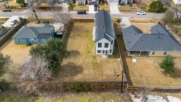 an aerial view of residential houses with outdoor space