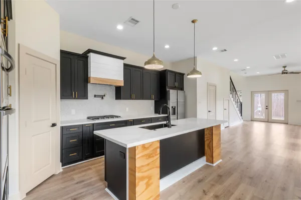 a kitchen with stainless steel appliances granite countertop a sink stove and refrigerator