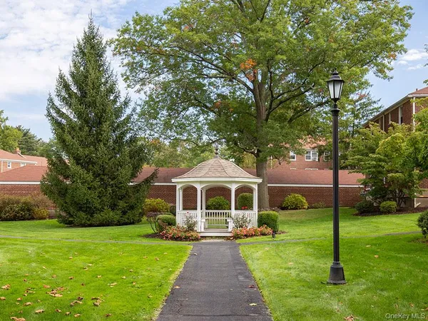 a front view of a house with yard and green space