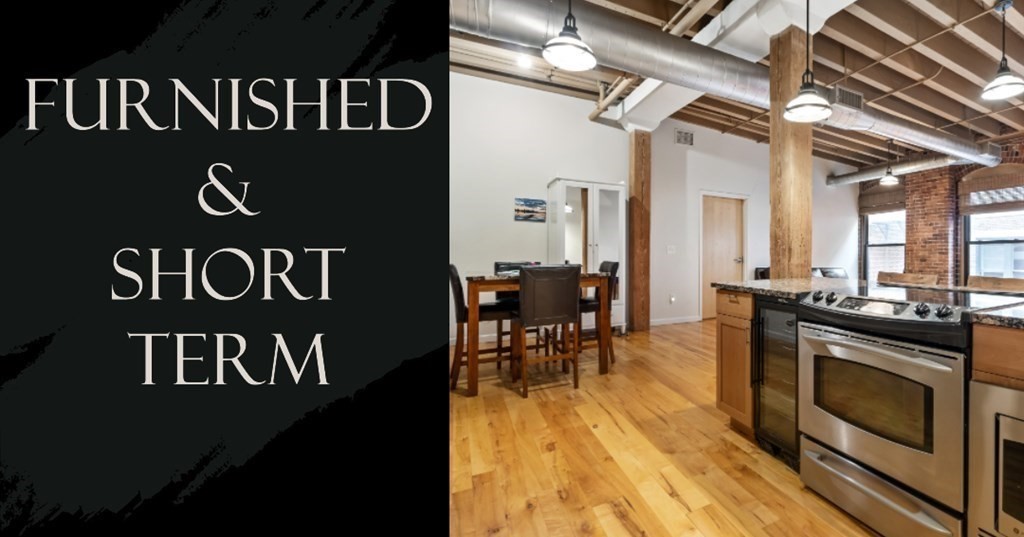 111 Beach Street, Unit 3D Boston, MA 02111 - Photo 1 of 10 a view of a kitchen with a table and chairs