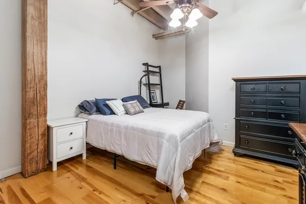 a bedroom with a bed and a chandelier