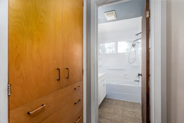 a bathroom with a glass shower door