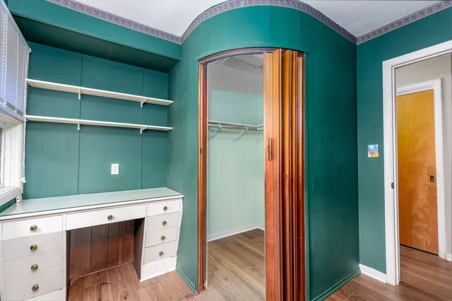 a kitchen with a refrigerator and cabinets