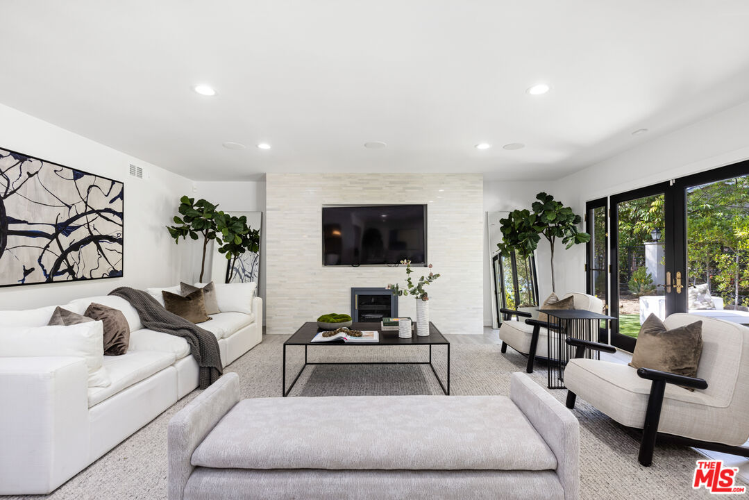 16167 Meadowcrest Road Sherman Oaks, CA 91403 - Photo 12 of 31 a living room with furniture and a flat screen tv