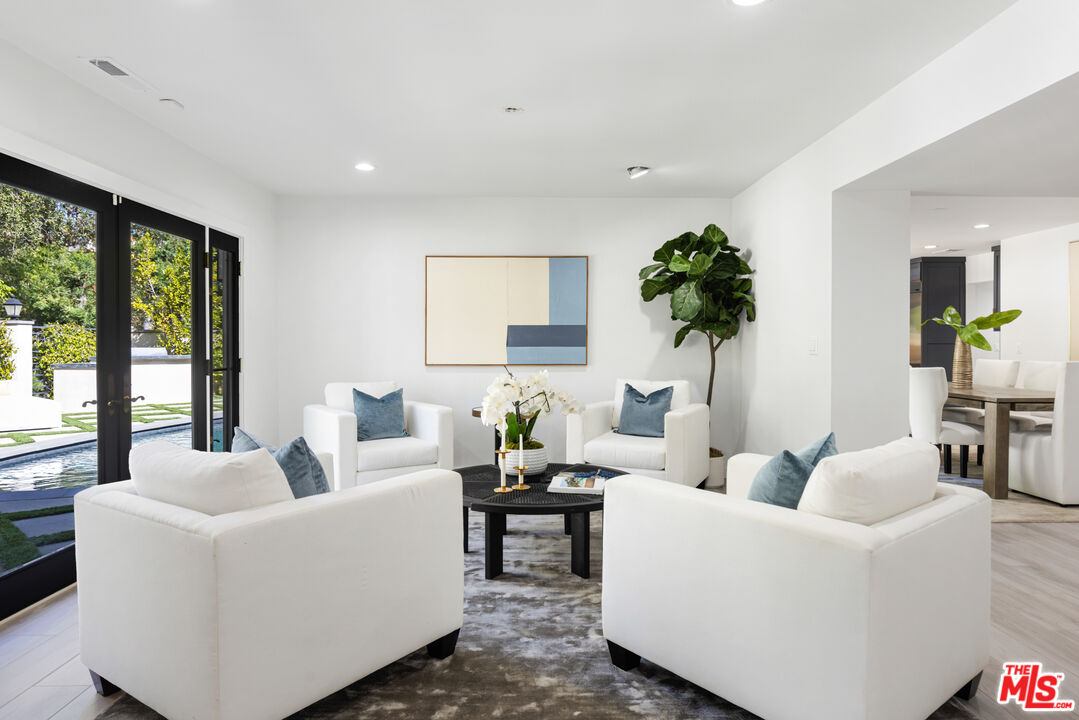 16167 Meadowcrest Road Sherman Oaks, CA 91403 - Photo 13 of 31 a living room with furniture and a potted plant