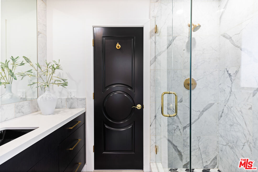 16167 Meadowcrest Road Sherman Oaks, CA 91403 - Photo 18 of 31 a bathroom with a sink and mirror