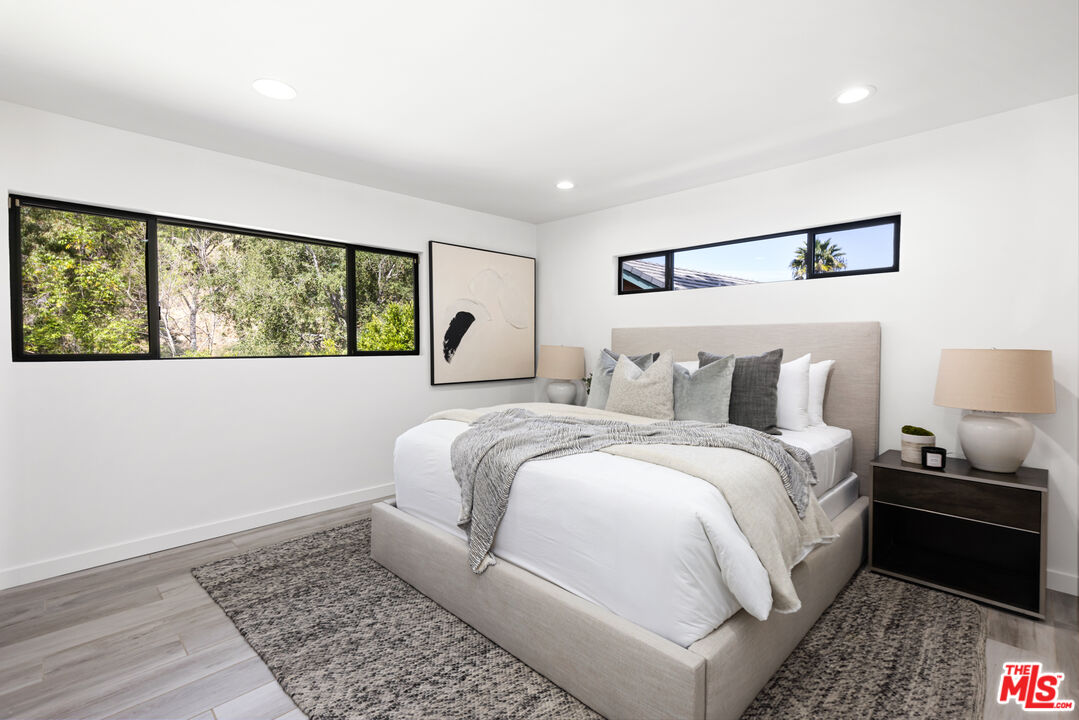 16167 Meadowcrest Road Sherman Oaks, CA 91403 - Photo 19 of 31 a large white bed in a white room