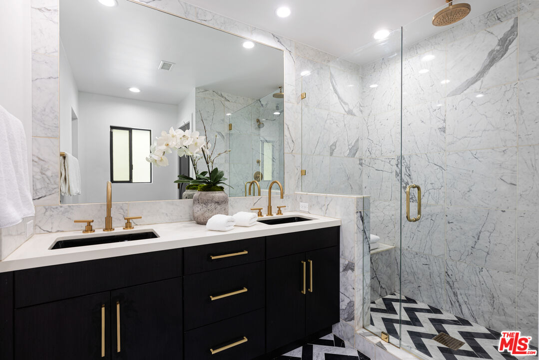 16167 Meadowcrest Road Sherman Oaks, CA 91403 - Photo 20 of 31 a bathroom with a double vanity sink mirror and shower