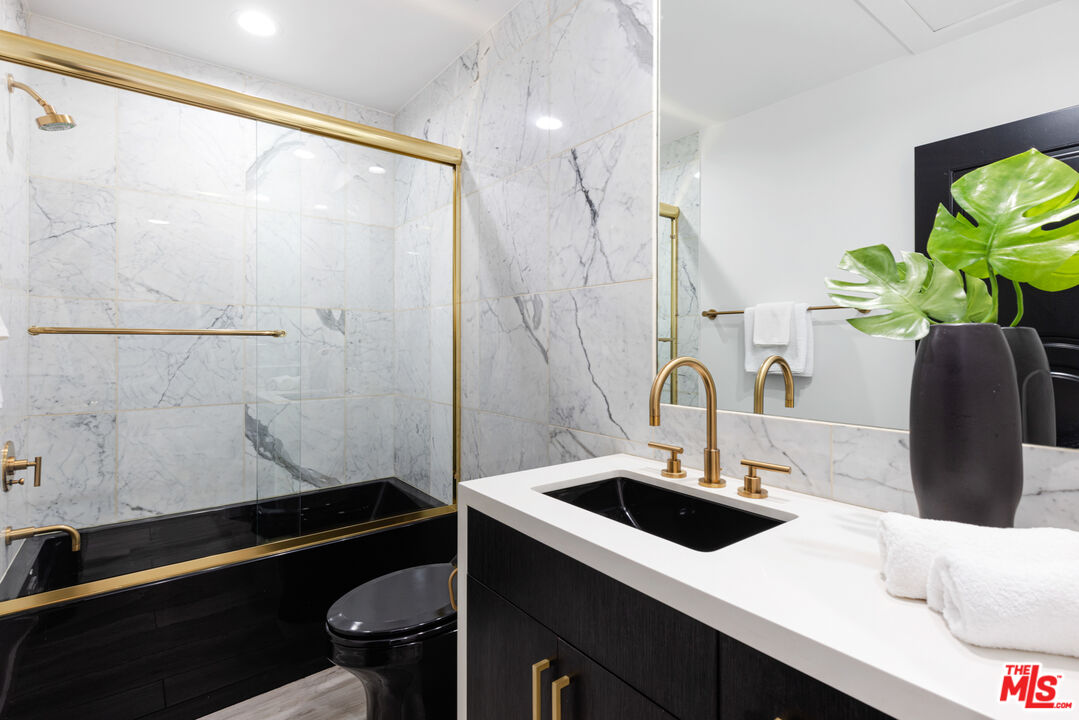 16167 Meadowcrest Road Sherman Oaks, CA 91403 - Photo 21 of 31 a bathroom with a sink and a mirror