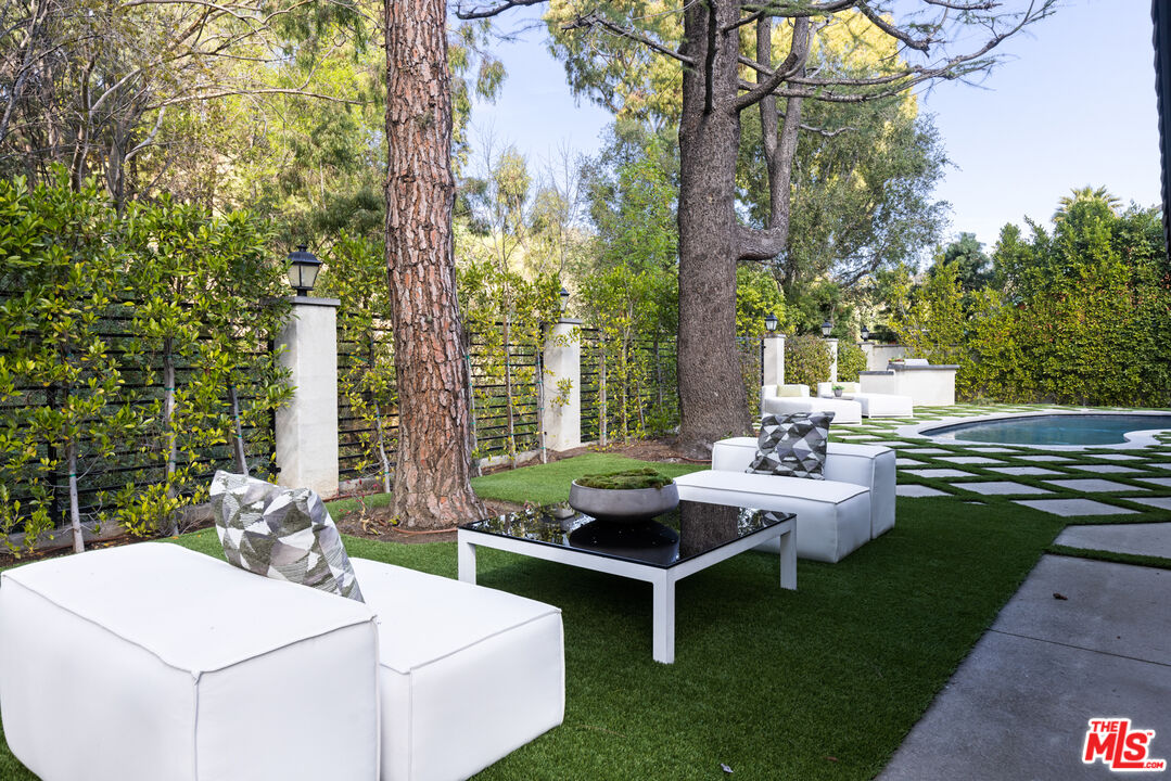 16167 Meadowcrest Road Sherman Oaks, CA 91403 - Photo 25 of 31 a backyard of a house with table and chairs