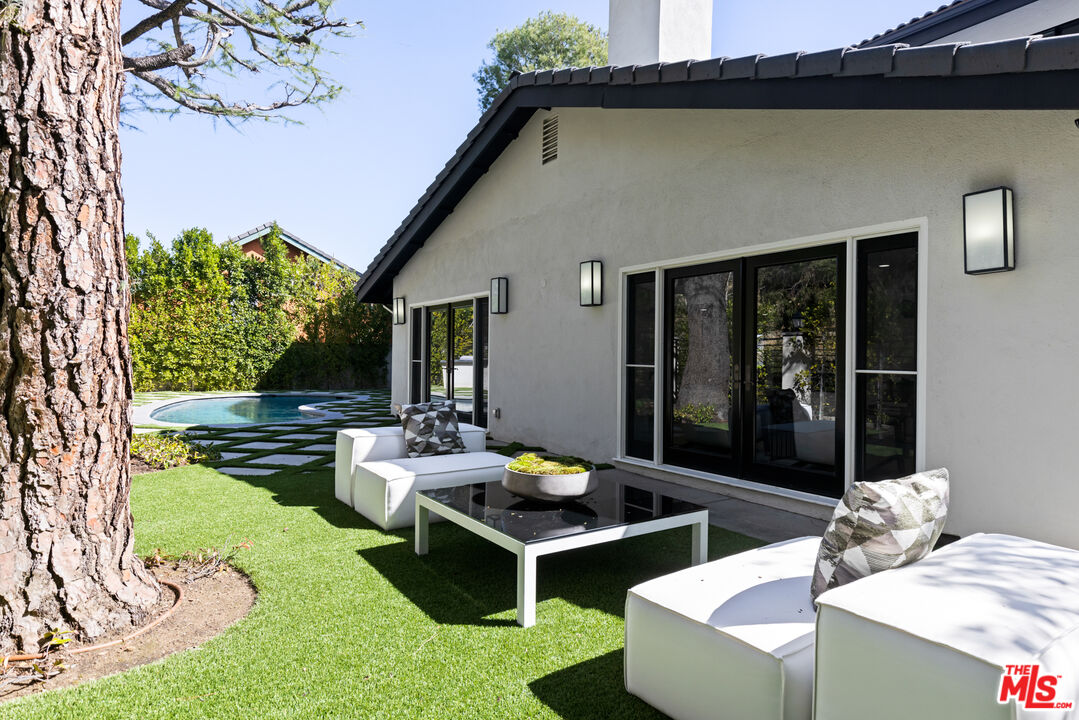16167 Meadowcrest Road Sherman Oaks, CA 91403 - Photo 30 of 31 a view of a patio with couches table and chairs and potted plants