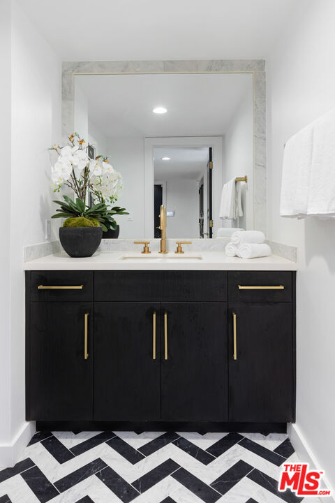 16167 Meadowcrest Road Sherman Oaks, CA 91403 - Photo 3 of 31 a bathroom with a sink a mirror and vanity