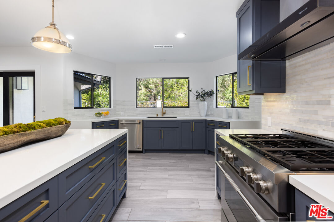 16167 Meadowcrest Road Sherman Oaks, CA 91403 - Photo 6 of 31 a kitchen with a stove sink and window