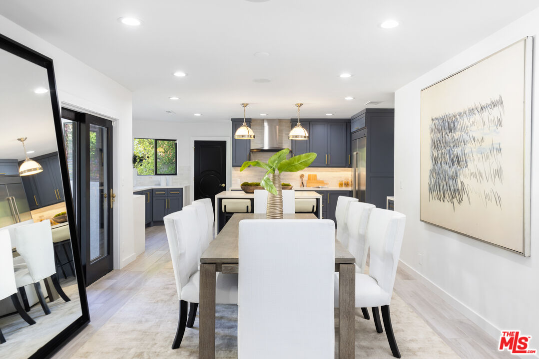 16167 Meadowcrest Road Sherman Oaks, CA 91403 - Photo 9 of 31 a view of a dining room with furniture window and wooden floor