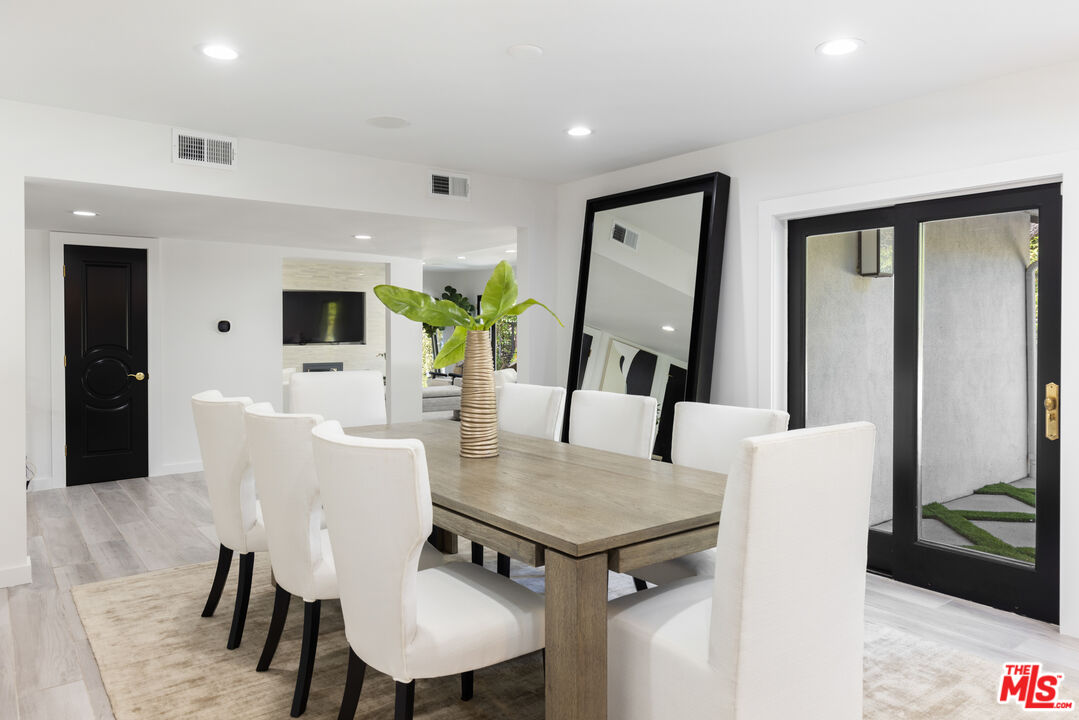 16167 Meadowcrest Road Sherman Oaks, CA 91403 - Photo 10 of 31 a view of a dining room with furniture and wooden floor