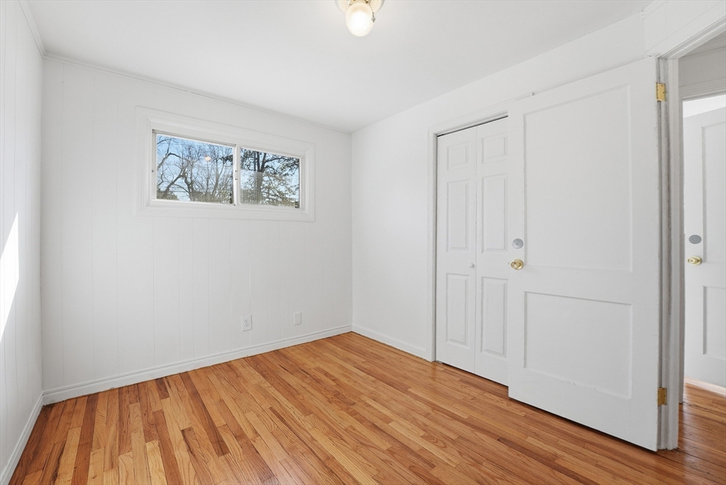 744 Bradley Road Springfield, MA 01109 - Photo 16 of 41 a view of an empty room with wooden floor