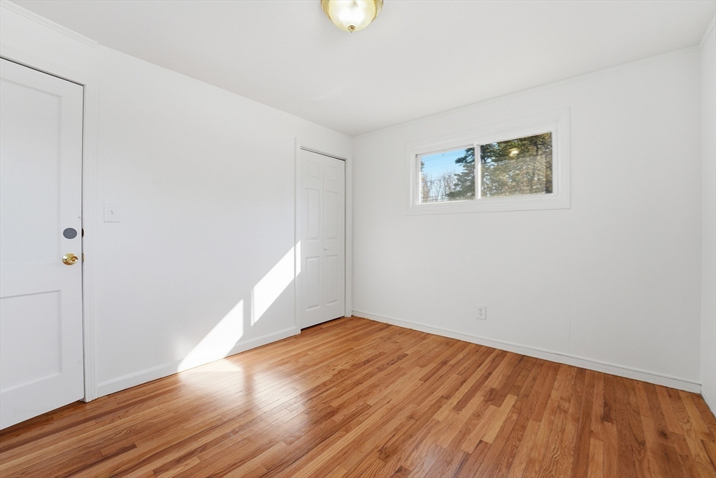 744 Bradley Road Springfield, MA 01109 - Photo 20 of 41 an empty room with wooden floor and windows