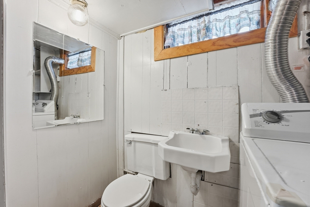744 Bradley Road Springfield, MA 01109 - Photo 33 of 41 a bathroom with a sink a toilet and mirror