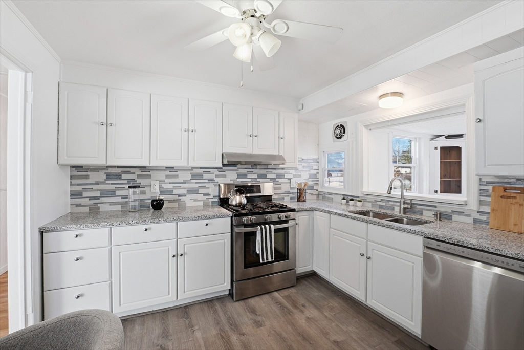 744 Bradley Road Springfield, MA 01109 - Photo 8 of 41 a kitchen with granite countertop a sink stainless steel appliances and cabinets