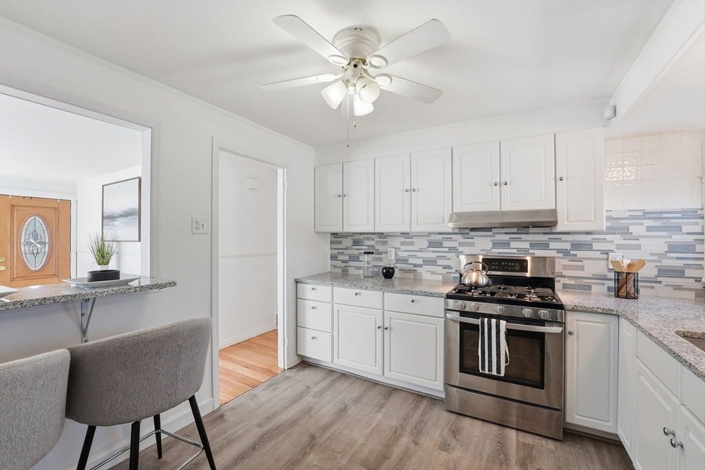 744 Bradley Road Springfield, MA 01109 - Photo 10 of 41 a kitchen with stainless steel appliances a stove a sink and cabinets