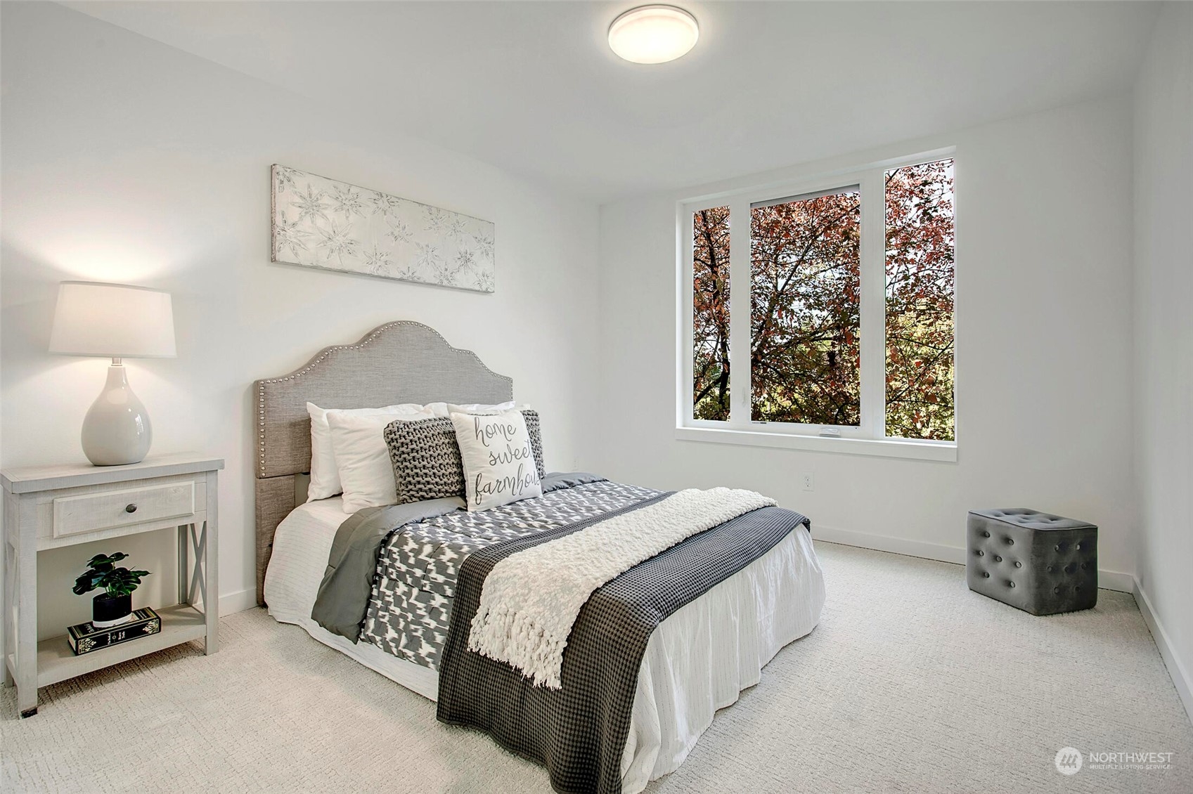 10170 Holman Road Northwest, Unit G Seattle, WA 98133 - Photo 11 of 23 a bedroom with a bed a couch and a window